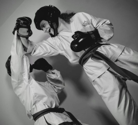 Sasha and her opponent during a Taekwondo training session.