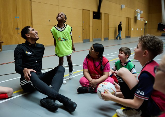 Jude Bellingham sitting down in a circle chatting with children who joined our blind and partially sighted football day in partnership with McDonald's Fun Football earlier this year.